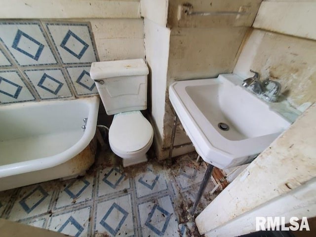 2327 7th St, Rock Island, IL 61201 - full bathroom with toilet, a bath, a sink, and tile patterned floors