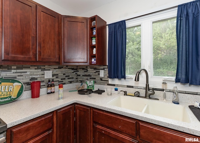 2908 N 4th St, Clinton, IA 52732 - kitchen featuring a sink, decorative backsplash, open shelves, light stone counters, and reddish brown cabinets