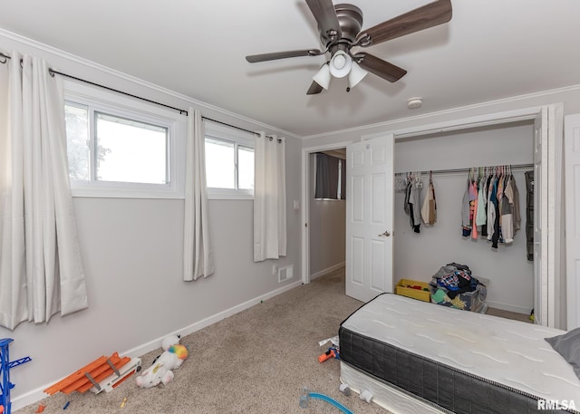2908 N 4th St, Clinton, IA 52732 - bedroom with baseboards, crown molding, carpet flooring, a ceiling fan, and a closet