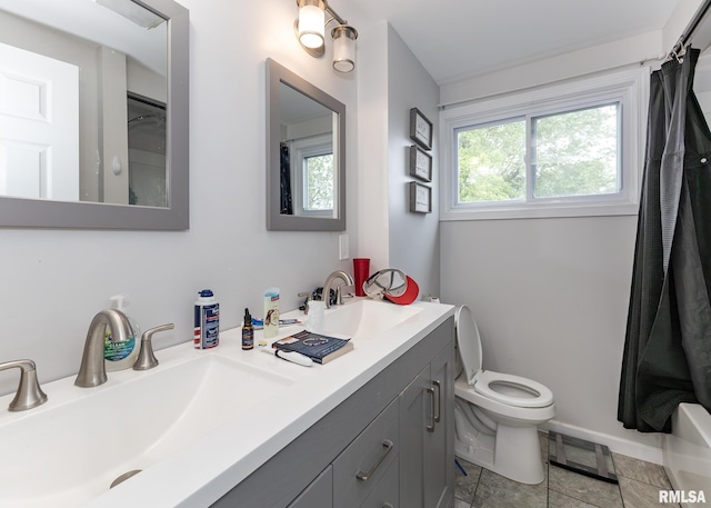 2908 N 4th St, Clinton, IA 52732 - bathroom featuring double vanity and toilet