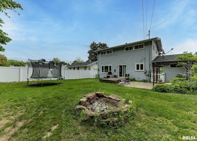 2908 N 4th St, Clinton, IA 52732 - back of house with a trampoline and a patio area