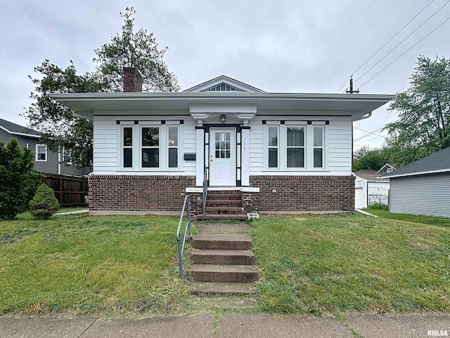 308 E Central Park Ave, Davenport, IA 52803 - bungalow-style house with brick siding, a chimney, and entry steps