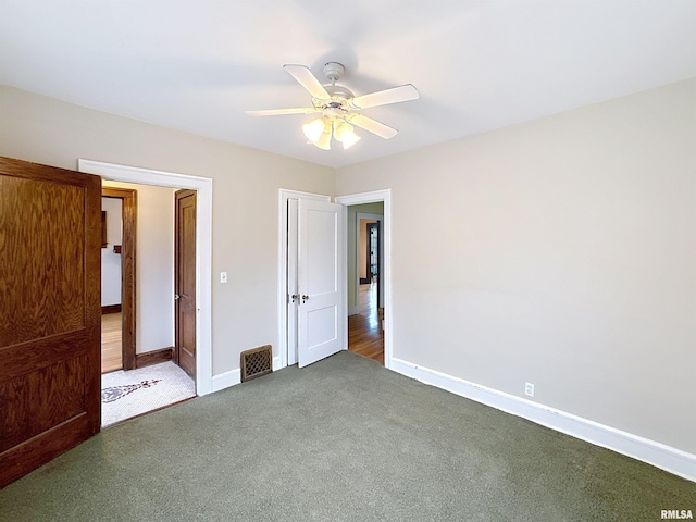 308 E Central Park Ave, Davenport, IA 52803 - unfurnished bedroom with carpet floors, baseboards, and ceiling fan