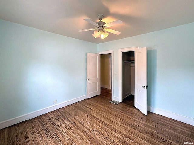 308 E Central Park Ave, Davenport, IA 52803 - unfurnished bedroom with baseboards, wood finished floors, a closet, and a ceiling fan