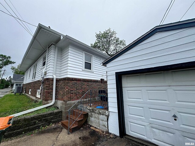 308 E Central Park Ave, Davenport, IA 52803 - view of side of property featuring brick siding and a garage