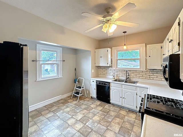 308 E Central Park Ave, Davenport, IA 52803 - kitchen with black appliances, a sink, decorative backsplash, and light countertops