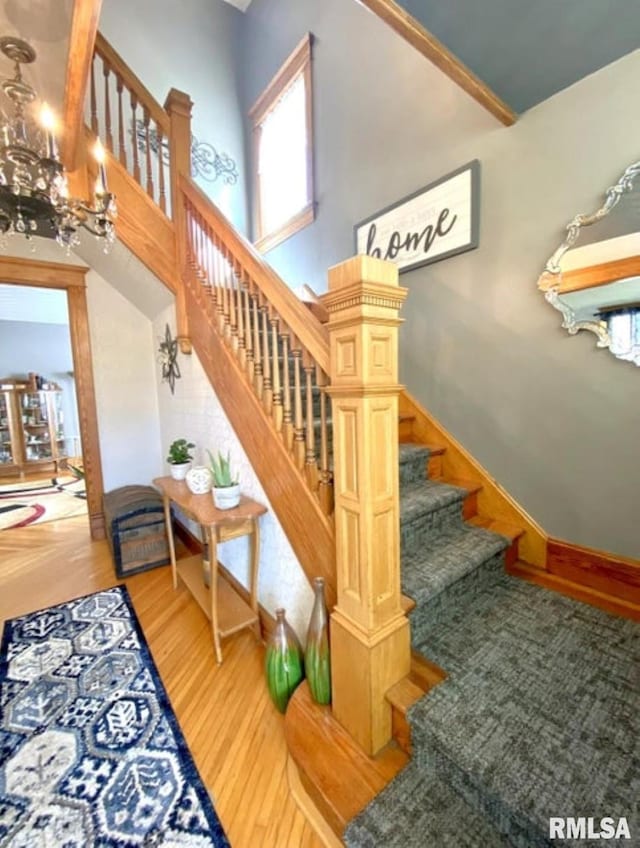 109 W 6th St, Wilton, IA 52778 - stairs with wood finished floors and a chandelier