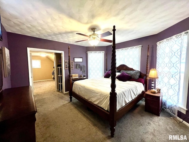 109 W 6th St, Wilton, IA 52778 - carpeted bedroom with a ceiling fan, baseboards, and a textured ceiling