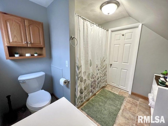 109 W 6th St, Wilton, IA 52778 - full bathroom featuring toilet, stone finish flooring, baseboards, and a shower with shower curtain