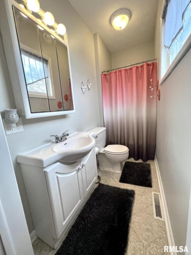 109 W 6th St, Wilton, IA 52778 - bathroom with toilet, vanity, baseboards, and a shower with curtain