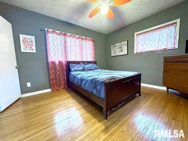 109 W 6th St, Wilton, IA 52778 - bedroom with hardwood / wood-style flooring, baseboards, and a ceiling fan