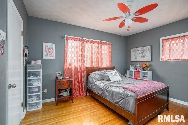 109 W 6th St, Wilton, IA 52778 - bedroom featuring wood finished floors, baseboards, and ceiling fan