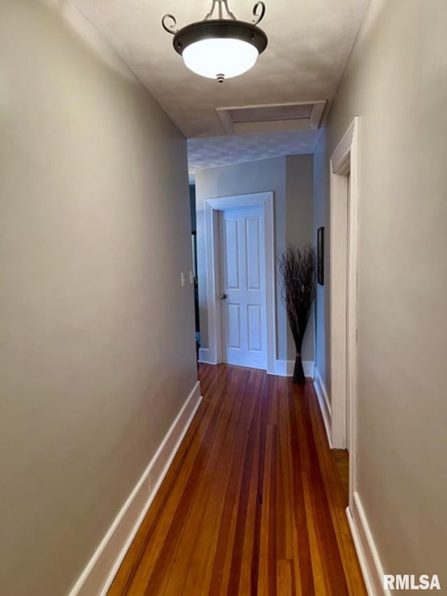 109 W 6th St, Wilton, IA 52778 - hallway with attic access, baseboards, and dark wood-style flooring
