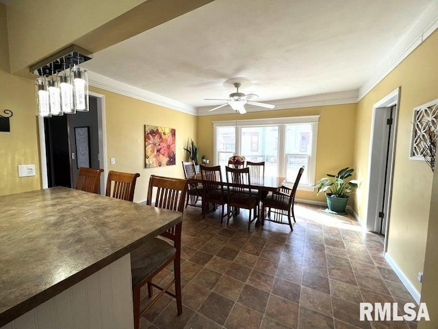 109 W 6th St, Wilton, IA 52778 - dining space with a ceiling fan, stone finish flooring, baseboards, and crown molding