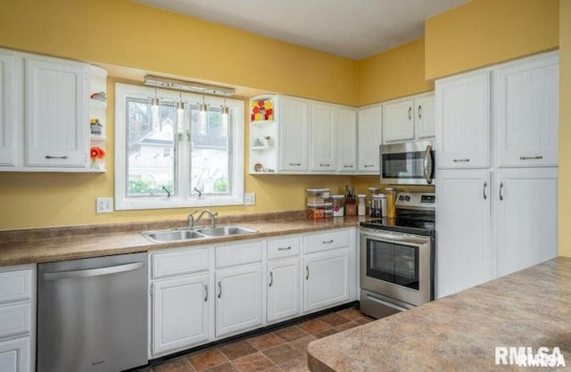 109 W 6th St, Wilton, IA 52778 - kitchen with stainless steel appliances, a sink, open shelves, and white cabinetry