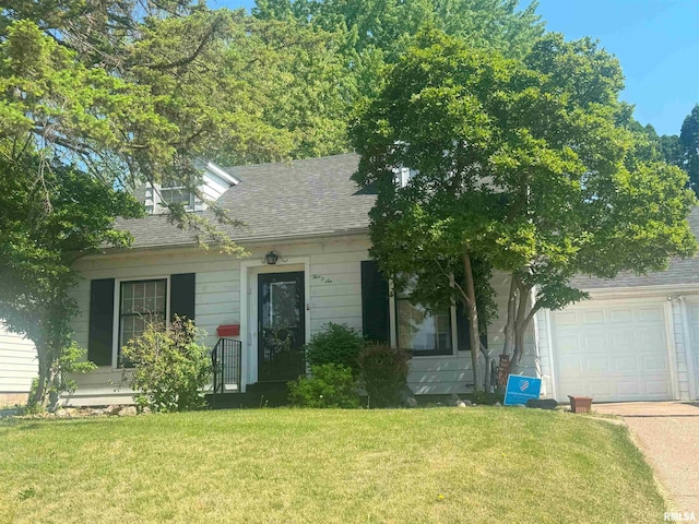 506 15th Ave N, Clinton, IA 52732 - view of front facade featuring a garage, a front lawn, roof with shingles, and driveway