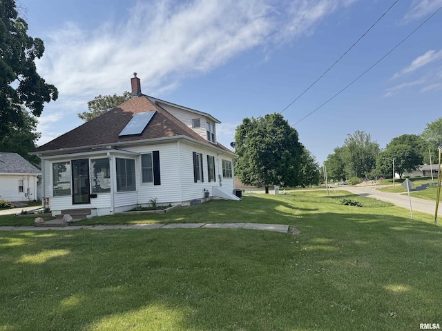 111 NE 5th St, Aledo, IL 61231 - view of side of property featuring a lawn, a chimney, and roof with shingles
