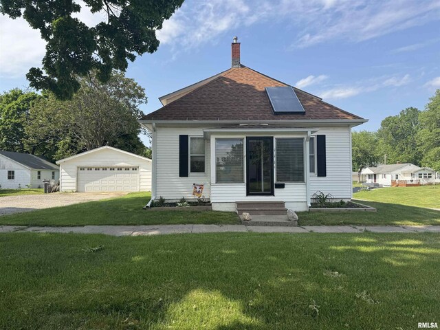 111 NE 5th St, Aledo, IL 61231 - bungalow-style home with a front yard, a chimney, entry steps, and a detached garage