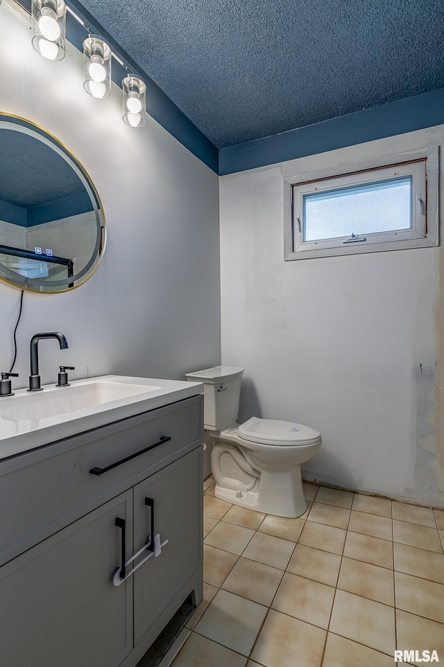 1656 Hitching Post Ln, Davenport, IA 52806 - bathroom with vanity, toilet, a textured ceiling, and tile patterned flooring