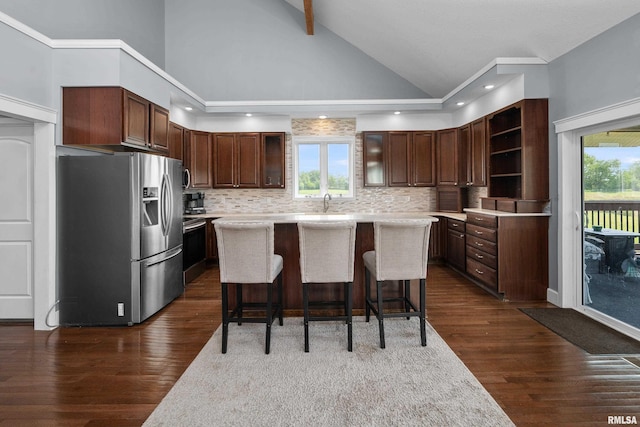 1335 N Utah Ave, Davenport, IA 52804 - kitchen featuring stainless steel refrigerator with ice dispenser, open shelves, light countertops, a center island, and a kitchen bar