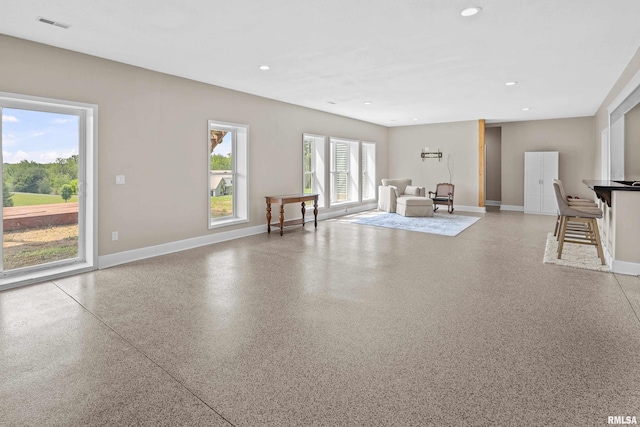 1335 N Utah Ave, Davenport, IA 52804 - living area featuring baseboards, recessed lighting, and speckle patterned floor