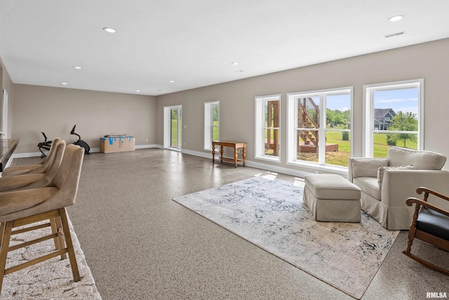 1335 N Utah Ave, Davenport, IA 52804 - living area with baseboards, recessed lighting, and speckle patterned floor