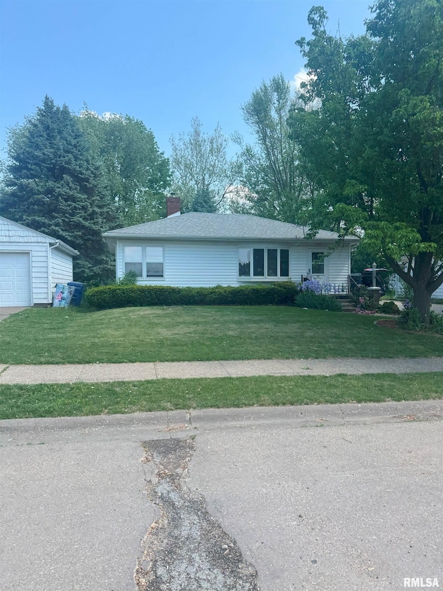 514 15th Ave N, Clinton, IA 52732 - ranch-style home with a front lawn, a chimney, a garage, and an outdoor structure
