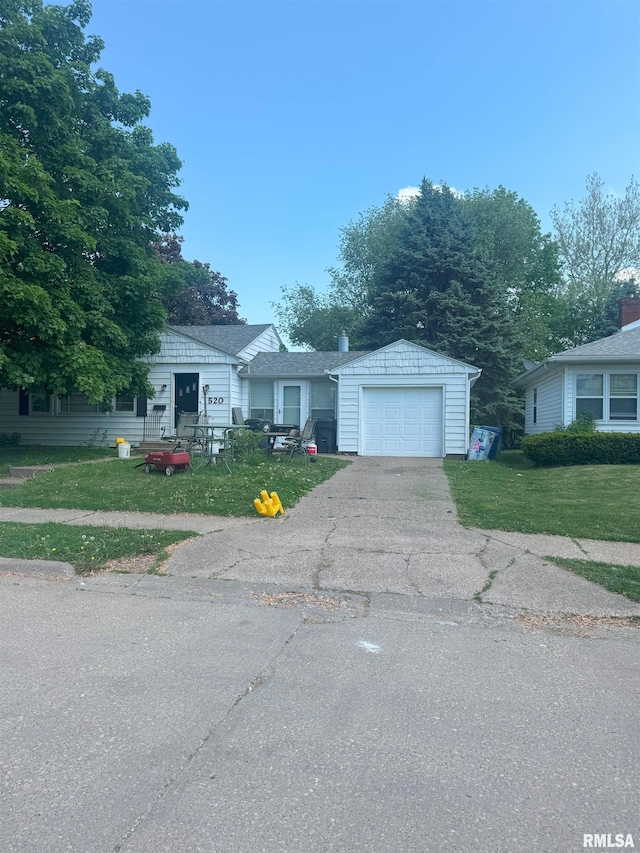 520 15th Ave N, Clinton, IA 52732 - view of front of house with asphalt driveway, a front lawn, and an attached garage