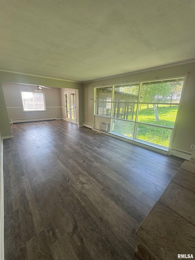 1510 Lazy Ln, Clinton, IA 52732 - unfurnished living room with a baseboard heating unit, dark wood-style floors, a wall mounted AC, and a textured ceiling