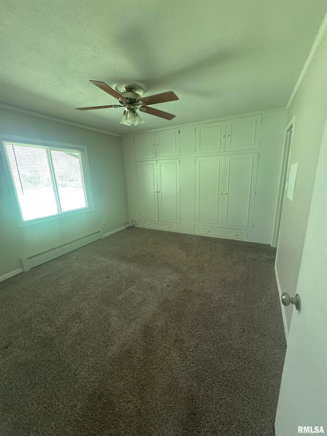 1510 Lazy Ln, Clinton, IA 52732 - unfurnished bedroom with a baseboard radiator, carpet flooring, a ceiling fan, and baseboards