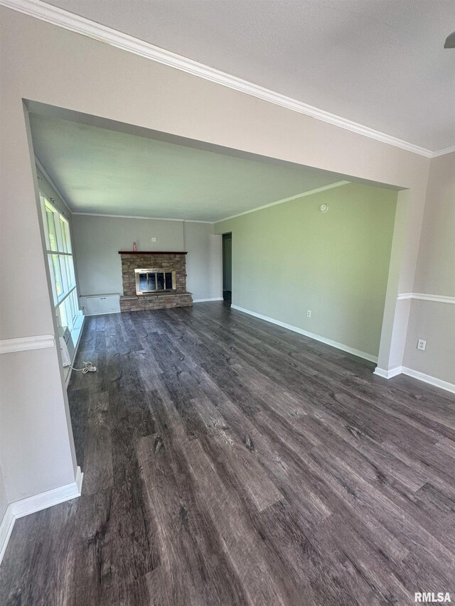 1510 Lazy Ln, Clinton, IA 52732 - unfurnished living room featuring dark wood-style floors, crown molding, baseboards, and a fireplace
