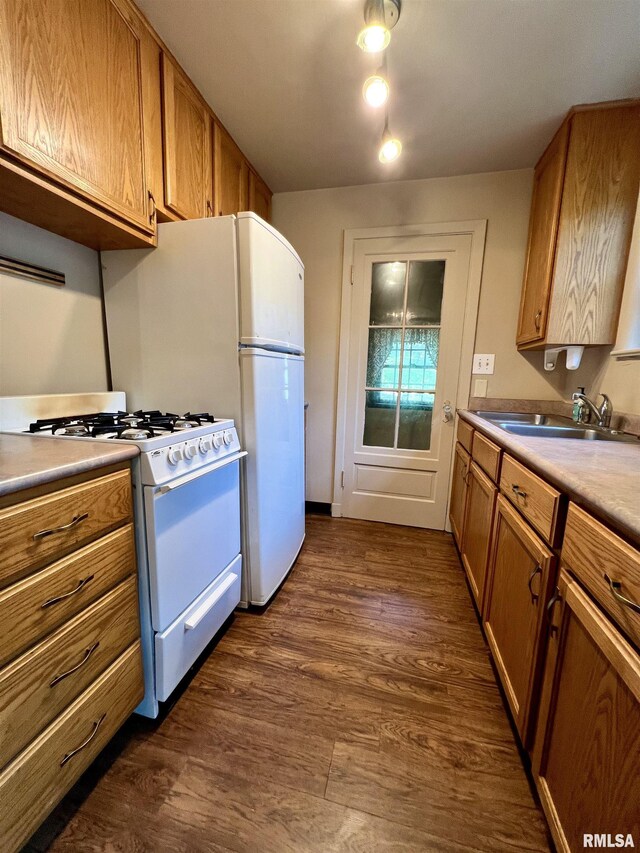 3752 12th St, Rock Island, IL 61201 - kitchen with white gas stove, a sink, brown cabinets, dark wood-style floors, and light countertops