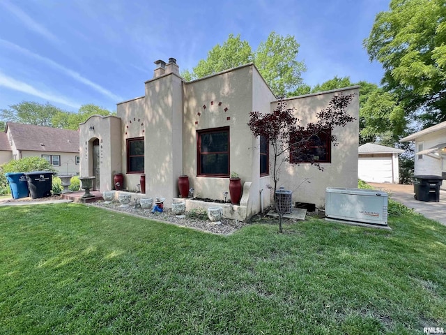 3752 12th St, Rock Island, IL 61201 - rear view of property featuring stucco siding, a chimney, and a yard