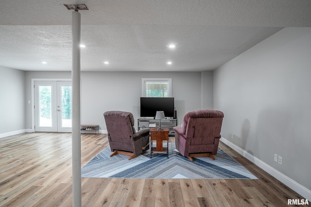6939 Cresthill Dr, Davenport, IA 52806 - living area featuring wood finished floors, baseboards, recessed lighting, healthy amount of natural light, and a textured ceiling