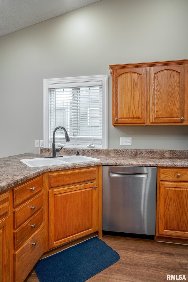 6939 Cresthill Dr, Davenport, IA 52806 - kitchen featuring dishwasher, a sink, wood finished floors, and brown cabinets