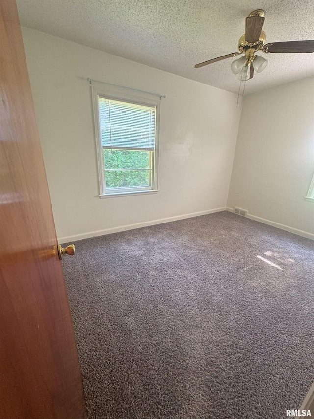 1515 Lazy Ln, Clinton, IA 52732 - carpeted empty room featuring a ceiling fan, a textured ceiling, and baseboards