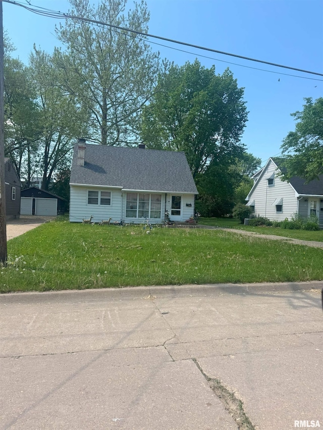 515 16th Ave N, Clinton, IA 52732 - view of front of home featuring a detached garage, a front yard, and a chimney