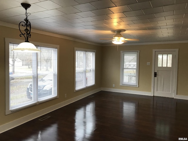 211 Chestnut St, Cambria, IL 62915 - unfurnished dining area featuring crown molding, healthy amount of natural light, a ceiling fan, baseboards, and dark wood-style floors