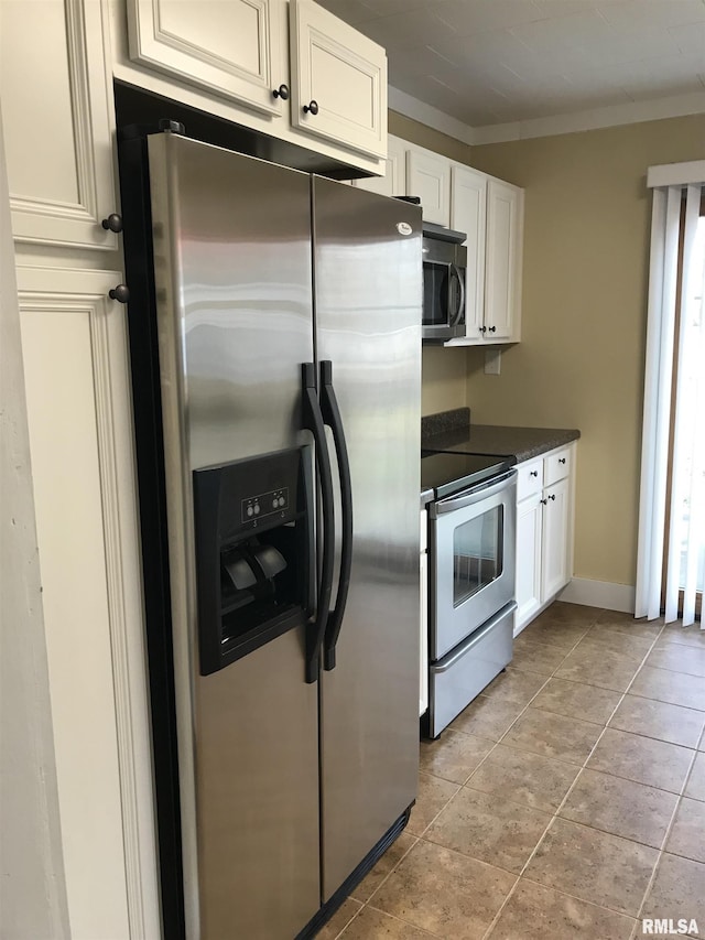 211 Chestnut St, Cambria, IL 62915 - kitchen with appliances with stainless steel finishes, dark countertops, white cabinets, ornamental molding, and baseboards