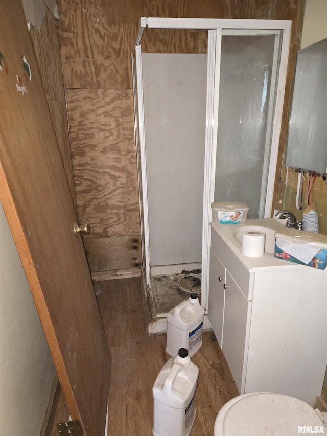 200 Muscatine St, Dixon, IA 52745 - full bath featuring wood finished floors, vanity, a shower stall, and toilet