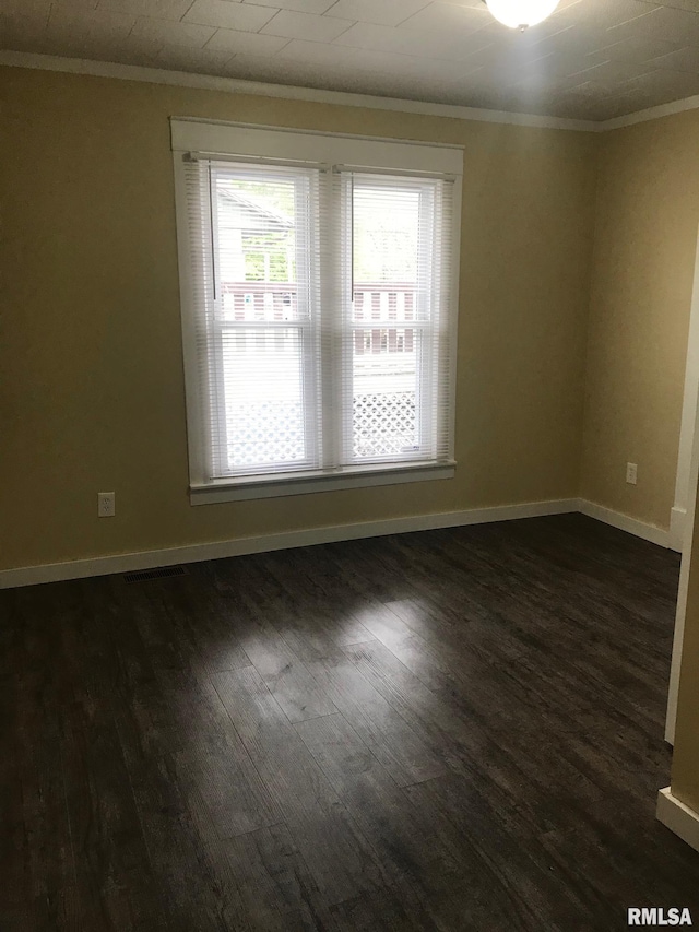 610 E Illinois Ave, Carterville, IL 62918 - empty room featuring ornamental molding, dark wood-type flooring, and baseboards