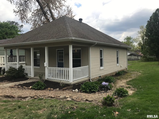 610 E Illinois Ave, Carterville, IL 62918 - view of side of home with a porch, a shingled roof, and a lawn