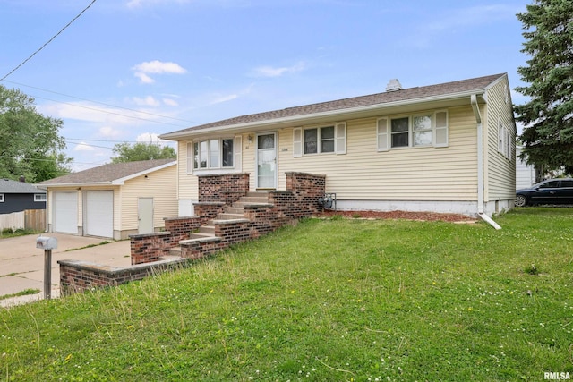 1206 10th Ave N, Clinton, IA 52732 - view of front of home with a detached garage, a front yard, and a chimney