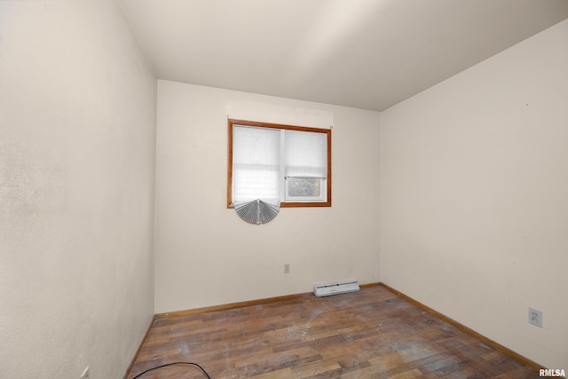 1206 10th Ave N, Clinton, IA 52732 - unfurnished room with a baseboard radiator, wood finished floors, and baseboards