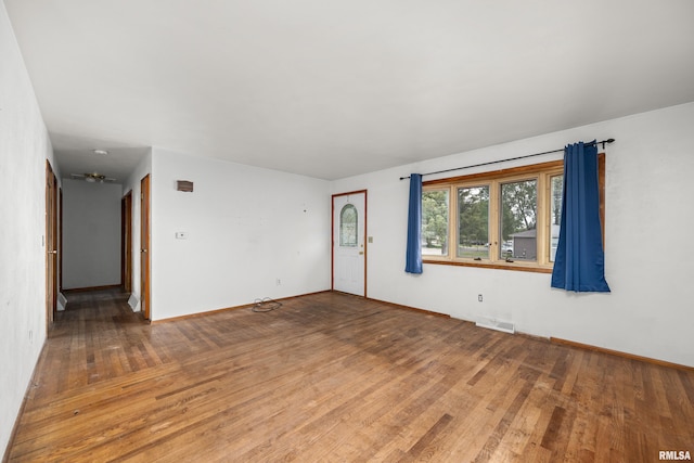 1206 10th Ave N, Clinton, IA 52732 - spare room with wood finished floors and baseboards