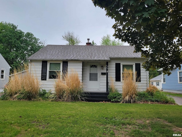 2322 4th St Unit A, East Moline, IL 61244 - view of front facade with a front yard, roof with shingles, and a chimney