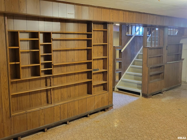 2322 4th St Unit A, East Moline, IL 61244 - below grade area with carpet floors, wood walls, and stairway