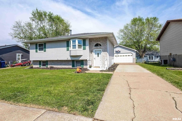 1413 N Pioneer St, Davenport, IA 52804 - split foyer home featuring central AC, a front yard, an outdoor structure, and a detached garage