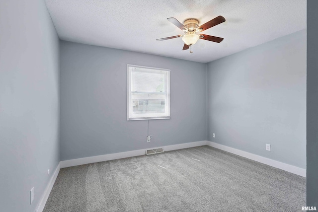 1413 N Pioneer St, Davenport, IA 52804 - spare room featuring a textured ceiling, a ceiling fan, carpet flooring, and baseboards