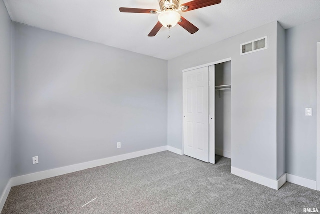1413 N Pioneer St, Davenport, IA 52804 - unfurnished bedroom with carpet, baseboards, a closet, and ceiling fan